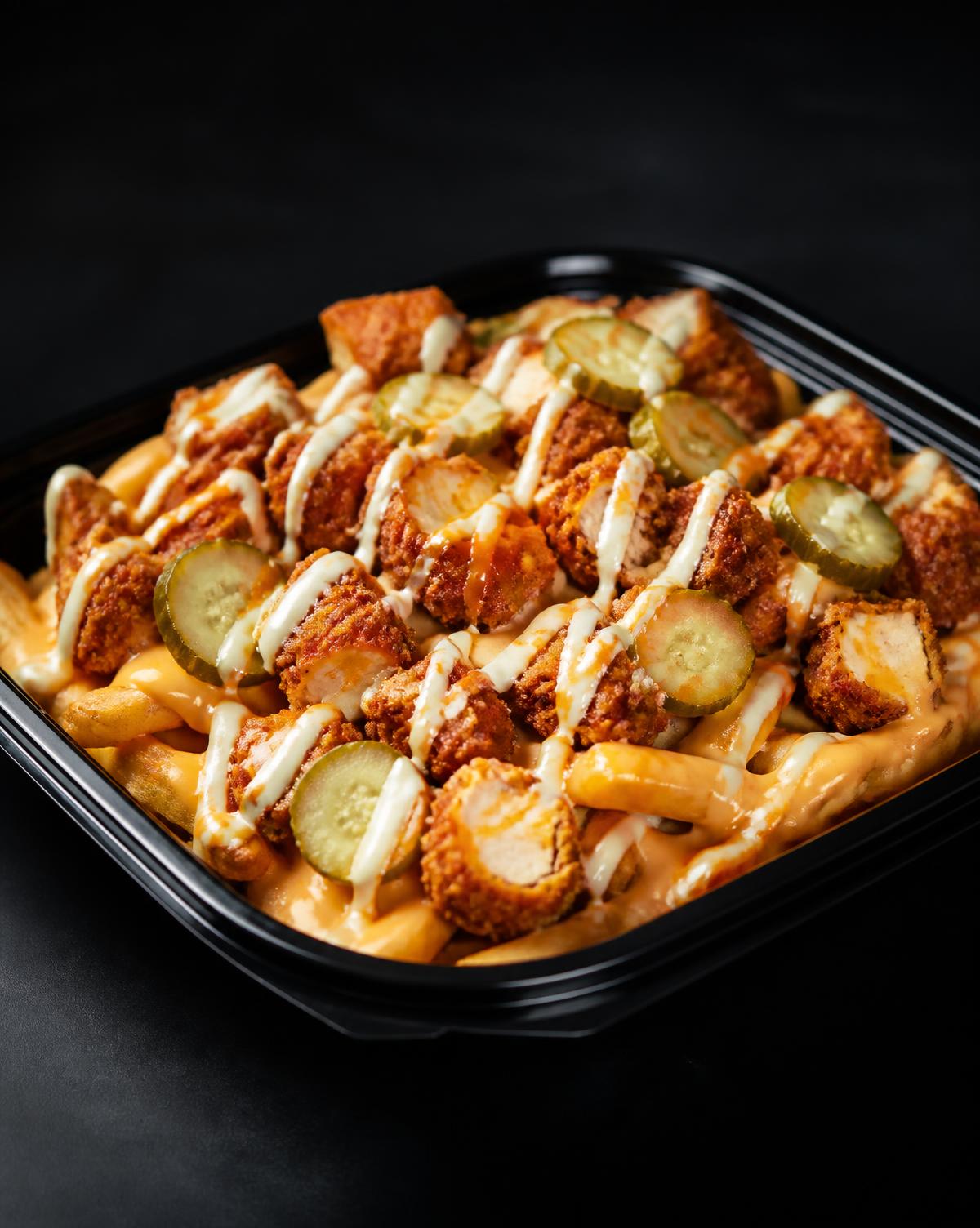Loaded fries topped with crispy hot chicken and cheese sauce